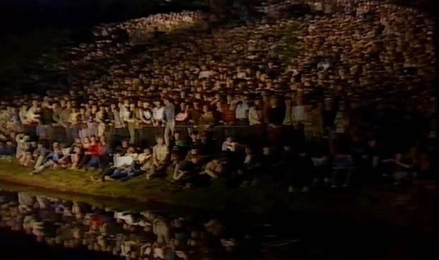 Echo & The Bunnymen in Sefton Park 1982 with the crowd watching from the grassy banks and water's edge